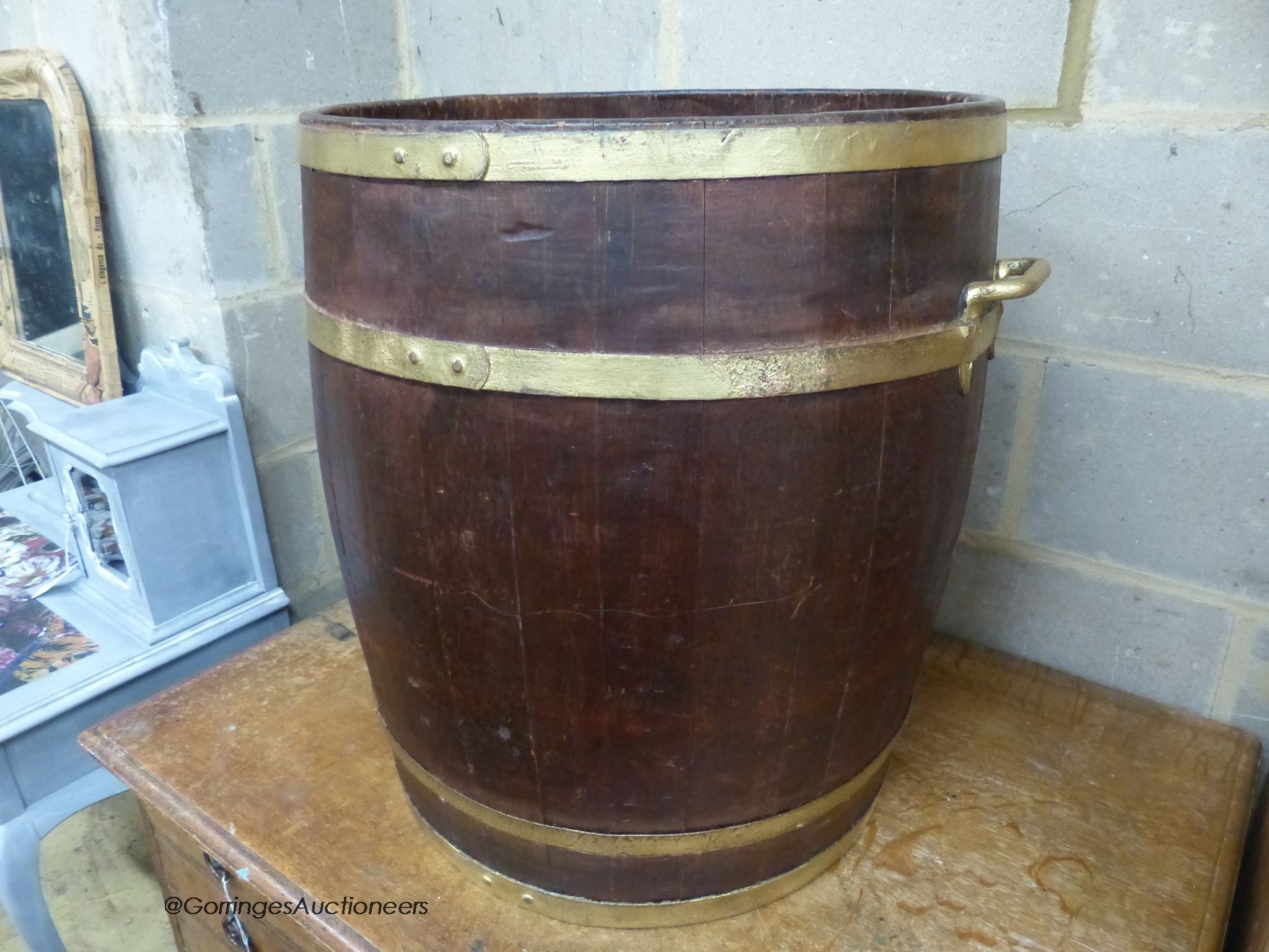 A circular staved oak two handled coopered barrel, 54cm diameter, height 58cm
